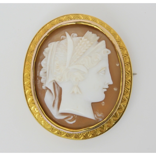 2827 - A WELL CARVED CAMEO BROOCHthe cameo of a maiden set into a bright yellow metal engraved brooch mount... 