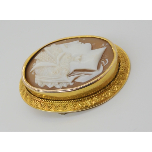 2827 - A WELL CARVED CAMEO BROOCHthe cameo of a maiden set into a bright yellow metal engraved brooch mount... 