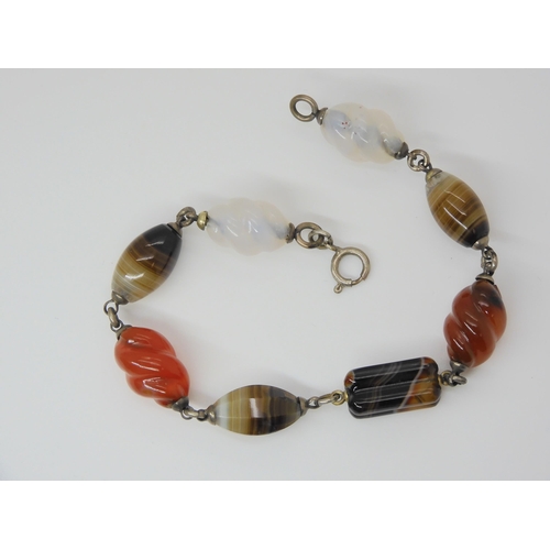 2840 - A CARVED SCOTTISH AGATE BRACELETwith some barley twist carved links, mounted in white metal. Length ... 