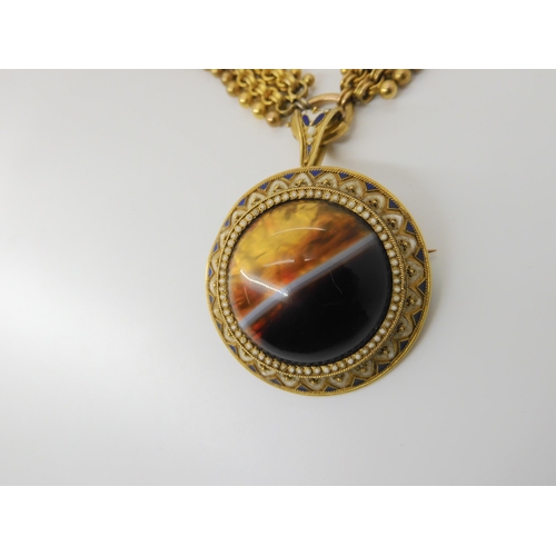 2842 - A VICTORIAN AGATE PENDANTcraftsman made in yellow metal mounted with a banded agate, with blue and w... 