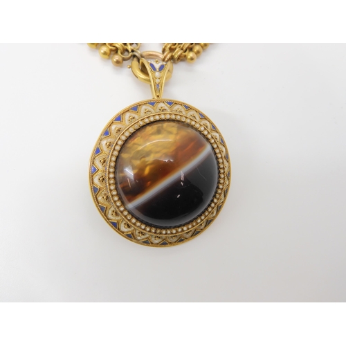 2842 - A VICTORIAN AGATE PENDANTcraftsman made in yellow metal mounted with a banded agate, with blue and w... 