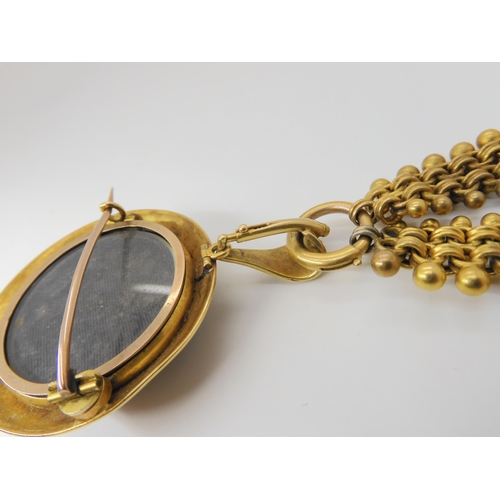 2842 - A VICTORIAN AGATE PENDANTcraftsman made in yellow metal mounted with a banded agate, with blue and w... 