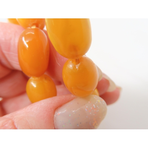 2843 - A STRING OF AMBER BEADSlargest bead 18mm x 12.4mm, smallest 13.3mm x 9.4mm, overall length 79cm, wei... 