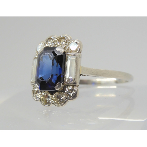 2848 - A SAPPHIRE & DIAMOND RINGset throughout in platinum, with a step cut sapphire of approximate dim... 