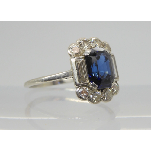 2848 - A SAPPHIRE & DIAMOND RINGset throughout in platinum, with a step cut sapphire of approximate dim... 