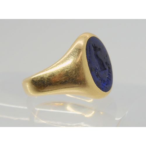 2849 - AN ITAGLIO SIGNET RINGset with a carved lapis lazuli, with Motto & Crest, 'watch over me'. Finge... 