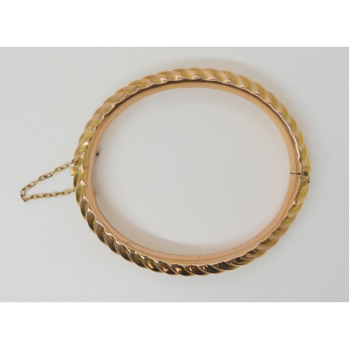 2852 - A 9CT BARLEY TWIST BANGLEin 9ct rose gold, made by Thomas Alston of Birmingham, with Birmingham hall... 