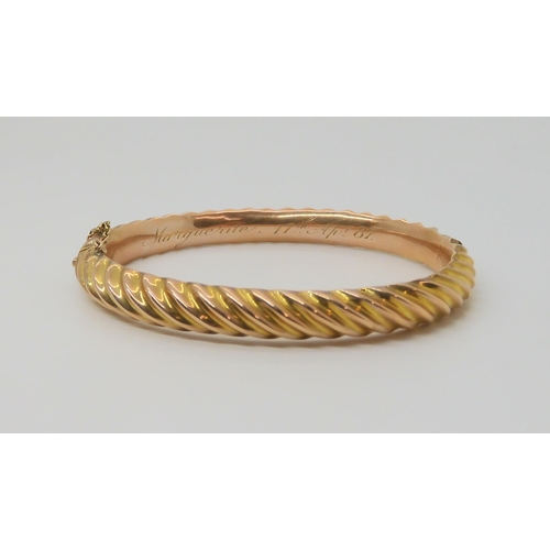 2852 - A 9CT BARLEY TWIST BANGLEin 9ct rose gold, made by Thomas Alston of Birmingham, with Birmingham hall... 