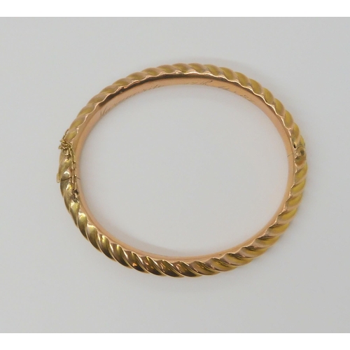 2852 - A 9CT BARLEY TWIST BANGLEin 9ct rose gold, made by Thomas Alston of Birmingham, with Birmingham hall... 