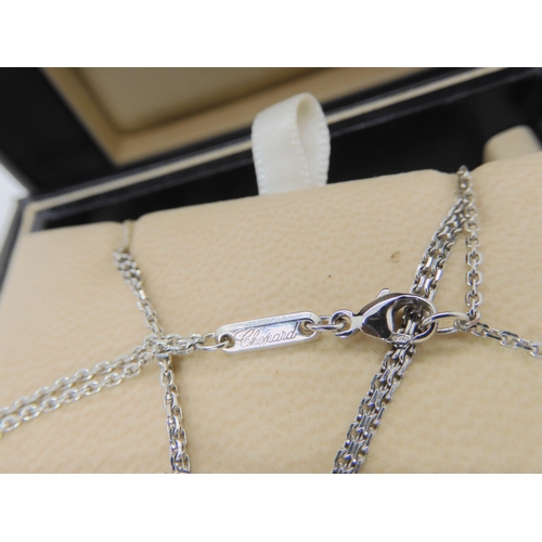 2854 - A CHOPARD HAPPY DIAMONDS PENDANT18k white gold round pendant and chain signed Chopard, 750, happy di... 