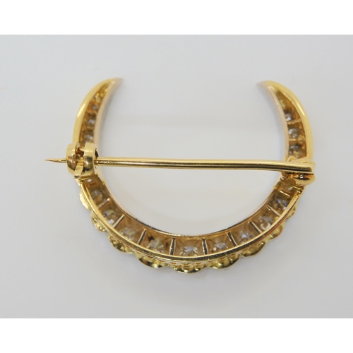 2858 - A DIAMOND CRESCENT MOON BROOCHset with estimated approx 0.70cts of brilliant cut diamonds, to the ga... 