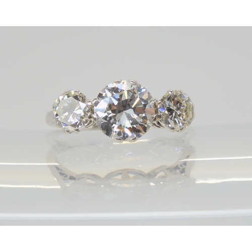 2861 - A SUBSTANTIAL DIAMOND THREE STONE RINGmounted throughout in platinum, with a really pretty setting. ... 