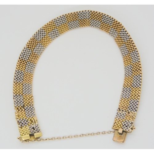 2864 - A CHEQUER BOARD PATTERN BRACELETmanufactured in yellow and white metal with a box clasp, length 19cm... 