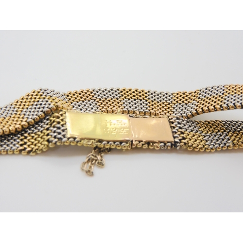 2864 - A CHEQUER BOARD PATTERN BRACELETmanufactured in yellow and white metal with a box clasp, length 19cm... 