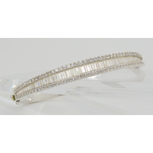 2865 - AN 18CT WHITE GOLD DIAMOND BANGLEset with estimated approx 3cts of baguette and brilliant cut diamon... 