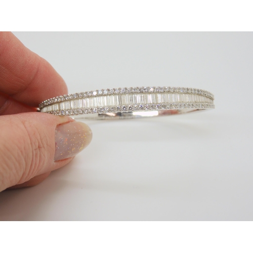 2865 - AN 18CT WHITE GOLD DIAMOND BANGLEset with estimated approx 3cts of baguette and brilliant cut diamon... 