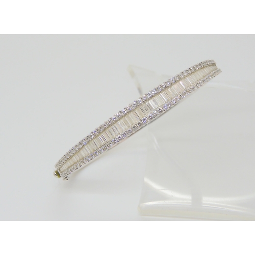 2865 - AN 18CT WHITE GOLD DIAMOND BANGLEset with estimated approx 3cts of baguette and brilliant cut diamon... 