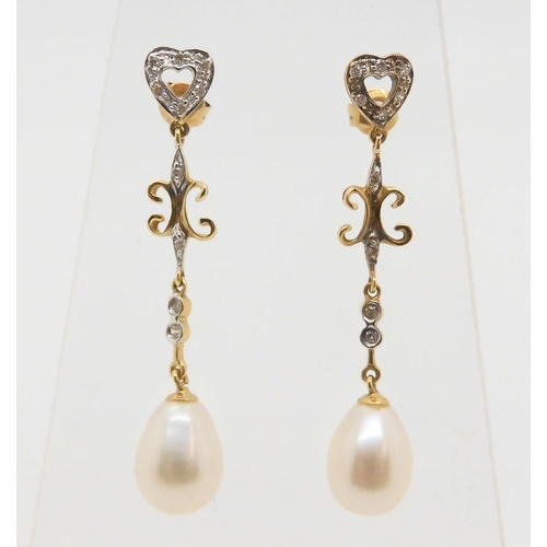 2869 - 14K GOLD PEARL AND DIAMOND EARRINGSthe pearls are approx 11mm x 8.5mm, with diamond accents, length ... 