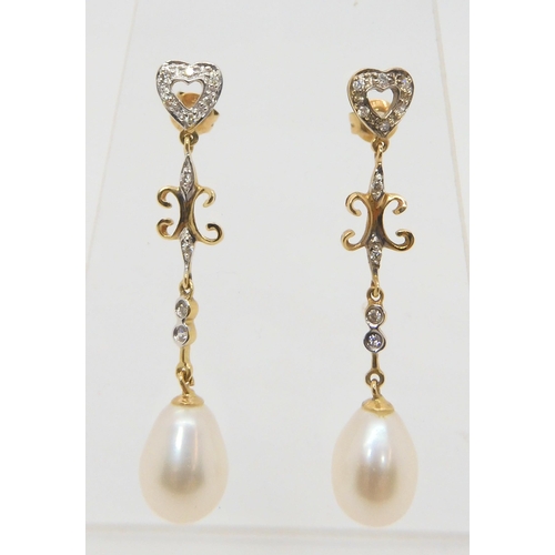 2869 - 14K GOLD PEARL AND DIAMOND EARRINGSthe pearls are approx 11mm x 8.5mm, with diamond accents, length ... 