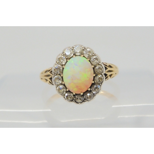 2872 - AN OPAL AND DIAMOND RINGset with a high domed opal of approx 8.8mm x 7.1mm x 4.1mm, surrounded with ... 