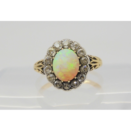 2872 - AN OPAL AND DIAMOND RINGset with a high domed opal of approx 8.8mm x 7.1mm x 4.1mm, surrounded with ... 