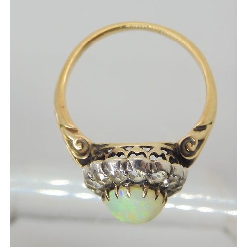 2872 - AN OPAL AND DIAMOND RINGset with a high domed opal of approx 8.8mm x 7.1mm x 4.1mm, surrounded with ... 