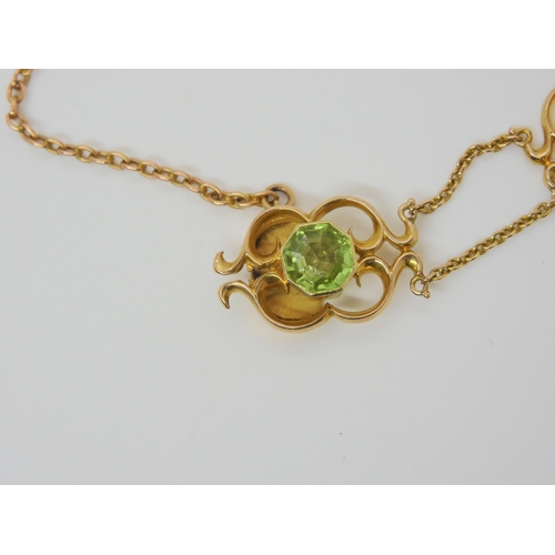 2877 - AN ARTS & CRAFTS BRACELETmounted in 15ct gold and set with hexagonal cut peridots, and mabe pear... 