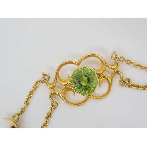 2877 - AN ARTS & CRAFTS BRACELETmounted in 15ct gold and set with hexagonal cut peridots, and mabe pear... 