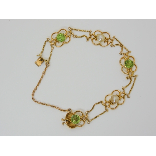 2877 - AN ARTS & CRAFTS BRACELETmounted in 15ct gold and set with hexagonal cut peridots, and mabe pear... 