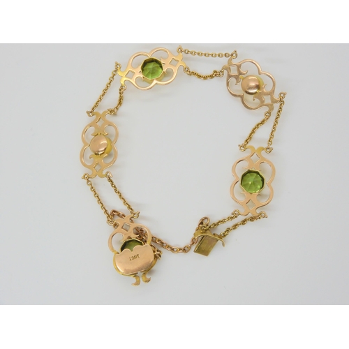 2877 - AN ARTS & CRAFTS BRACELETmounted in 15ct gold and set with hexagonal cut peridots, and mabe pear... 