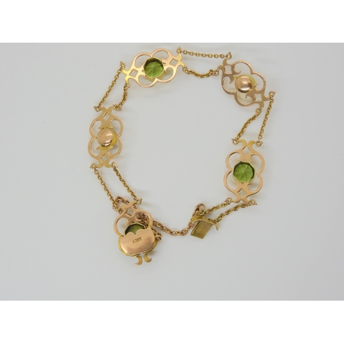 2877 - AN ARTS & CRAFTS BRACELETmounted in 15ct gold and set with hexagonal cut peridots, and mabe pear... 