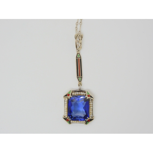 2883 - A 14K ART DECO PENDANTset with a large faux sapphire, with enamelled details, and seed pearls. Lengt... 