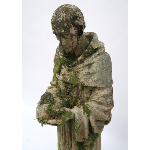 2068 - A 20TH CENTURY STONEWARE STATUE OF ST. FRANCISwith the robed figure clutching a dove, 91cm high... 