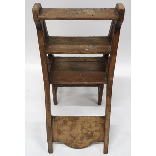 2070 - AN EARLY 20TH CENTURY OAK ARTS AND CRAFTS METAMORPHIC LIBRARY CHAIRwith plain splat carved with rond... 