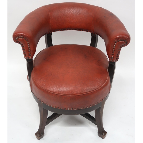 2071 - A LATE VICTORIAN MAHOGANY FRAMED SWIVEL CAPTAINS CHAIRwith red rexine upholstery on stretchered outs... 