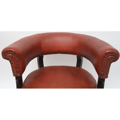 2071 - A LATE VICTORIAN MAHOGANY FRAMED SWIVEL CAPTAINS CHAIRwith red rexine upholstery on stretchered outs... 