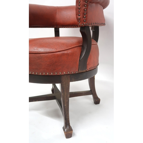 2071 - A LATE VICTORIAN MAHOGANY FRAMED SWIVEL CAPTAINS CHAIRwith red rexine upholstery on stretchered outs... 