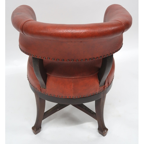 2071 - A LATE VICTORIAN MAHOGANY FRAMED SWIVEL CAPTAINS CHAIRwith red rexine upholstery on stretchered outs... 