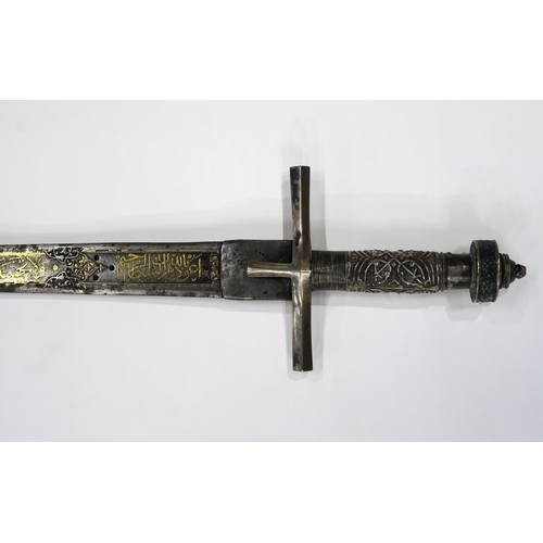 2667 - A NORTHEAST AFRICAN KASKARA SWORDThe Damascene blade inlaid with yellow metal Arabic script along it... 