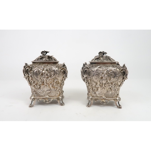 2497 - A PAIR OF WILLIAM IV SILVER CHINOSERIE TEA CADDIESof bombe form, profusely chased with rococo scroll... 