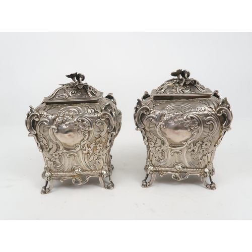 2497 - A PAIR OF WILLIAM IV SILVER CHINOSERIE TEA CADDIESof bombe form, profusely chased with rococo scroll... 