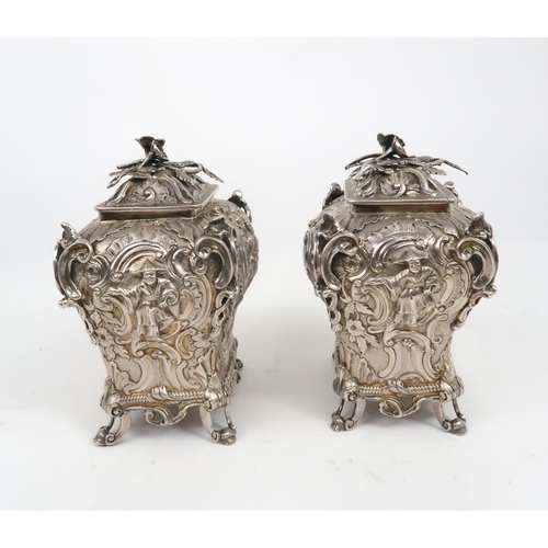 2497 - A PAIR OF WILLIAM IV SILVER CHINOSERIE TEA CADDIESof bombe form, profusely chased with rococo scroll... 