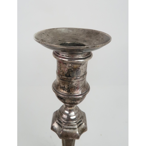 2502 - A PAIR OF EDWARDIAN SILVER CANDLESTICKSthe faceted knopped stem supported on a further capstan stem,... 