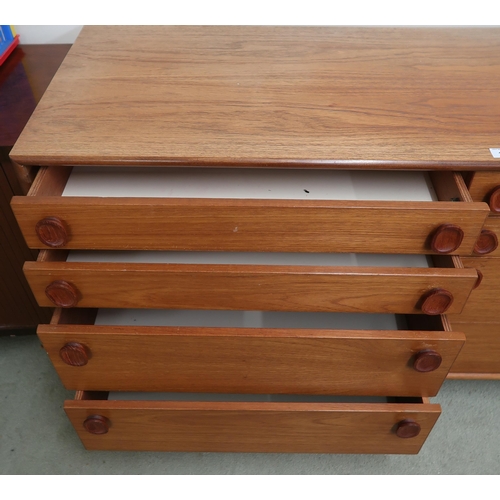 107 - A mid 20th century teak Meredew bank of eight drawers with pairs of graduating drawers on turned sup... 