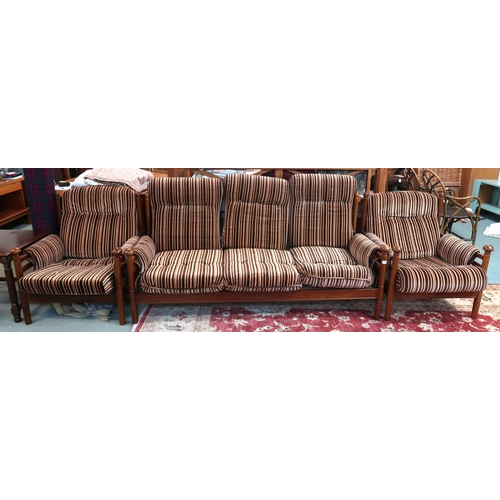 124 - A mid 20th century teak framed Guy Rogers three piece suite consisting three seater settee, 83cm hig... 