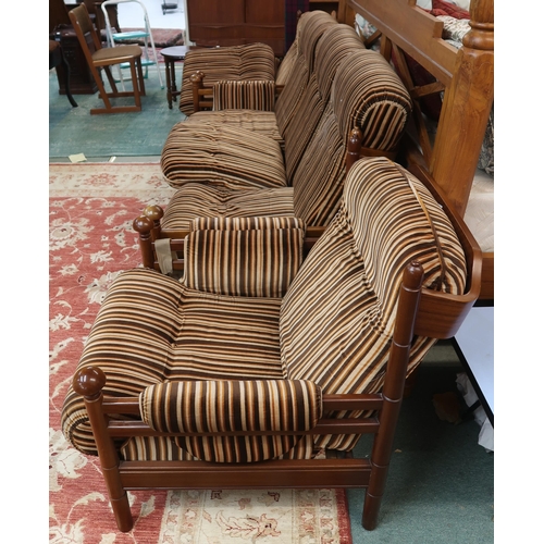 124 - A mid 20th century teak framed Guy Rogers three piece suite consisting three seater settee, 83cm hig... 