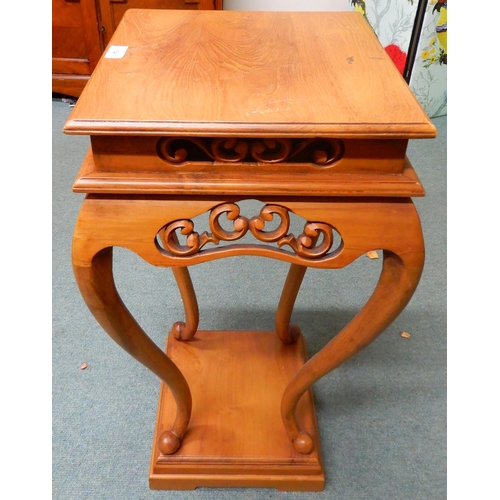 14 - A contemporary square topped single drawer jardinière stand with carved fretwork friezes over cabrio... 