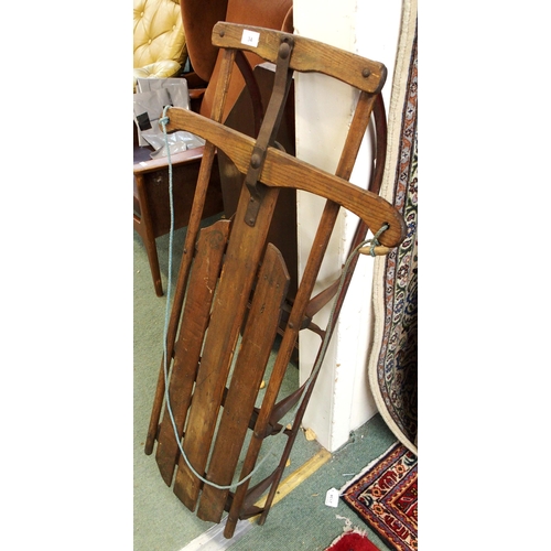 34 - A 20th century beech and iron child's sled, 115cm long x 58cm wide x 19cm high