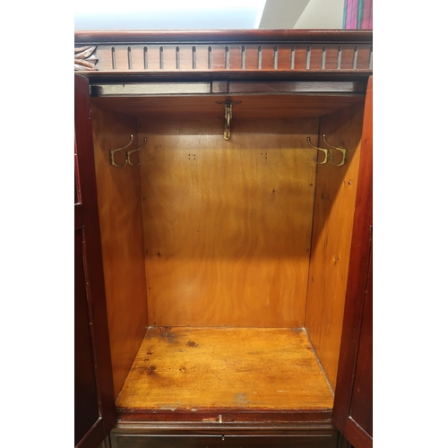 38 - A Victorian mahogany mirror door compactum wardrobe with single mirror door to the left of pair of c... 