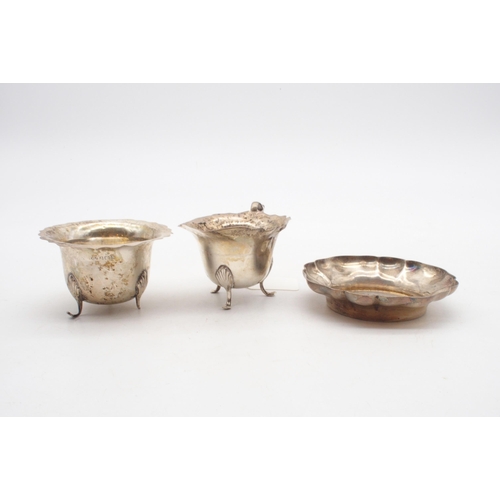 401A - A silver sugar bowl and cream jug, with a shaped rim, on four out-swept shell feet, by Marson & ... 